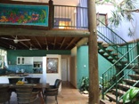 The open kitchen-dining-lounge area joins the internal balcony and garden space to create the lush hub of family life. The bare timber and massive logs combined with earthly tasteful terra-cotta flooring and unique sand finish of the walls complement the rustic environment of the ocean, the islands and the shores