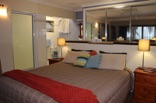 The main bedroom (on the second floor) is designed with communication and style as main targets. The unique open plan bathroom and walk-in wardrobe serve this purpose well while the timber floors and artistic coconut finishes complement the general house theme of earthliness  