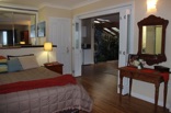 The privacy of the main bedroom suite can be broken by opening concertina sliding doors into a large home office space