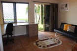 Sliding doors provide direct access to the front garden and deck. The bathroom poses separate shower and bath options
