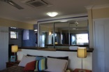 Even looking back into the room reveals the seascape reflected in the large mirror doors of the open plan ensuite